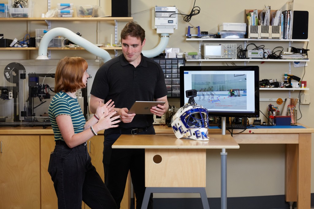 Two U N E students work together in the Makerspace