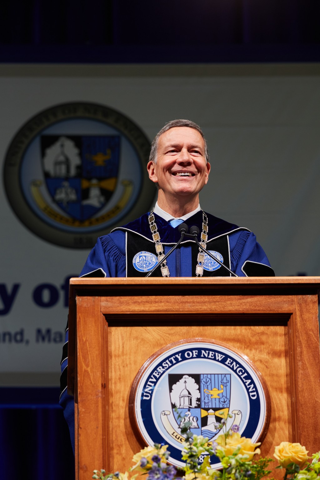 UNE President James Herbert smiles at the podium