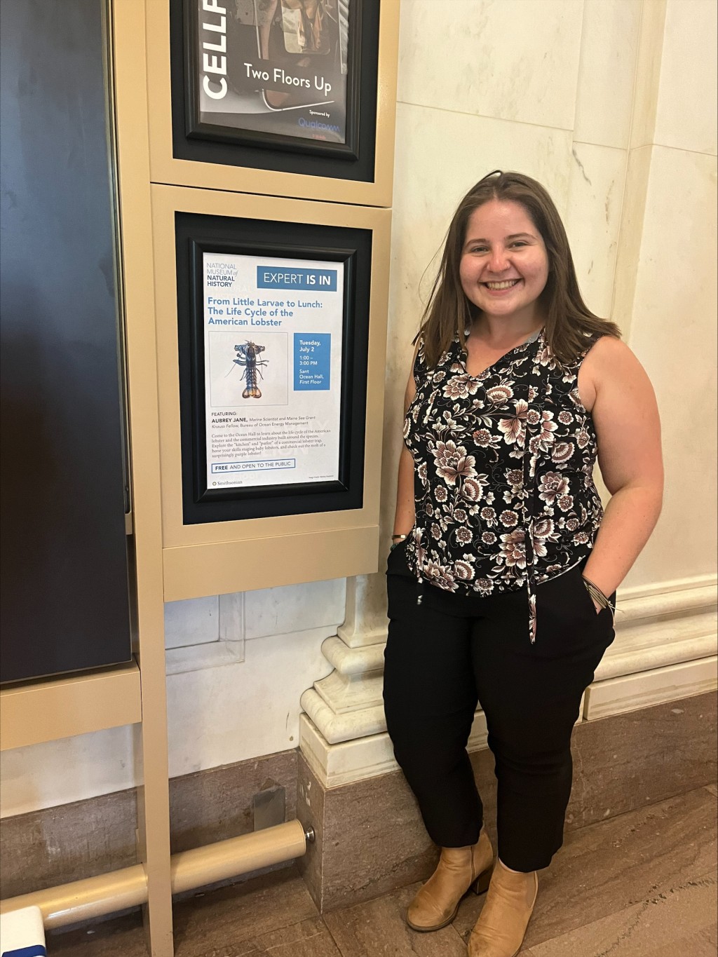 UNE researcher Aubrey Jane poses with a poster featuring her project