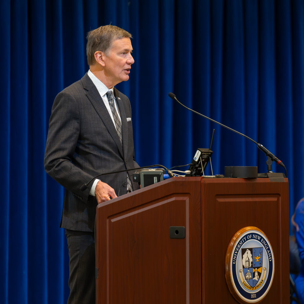 UNE President James Herbert speaks at the podium