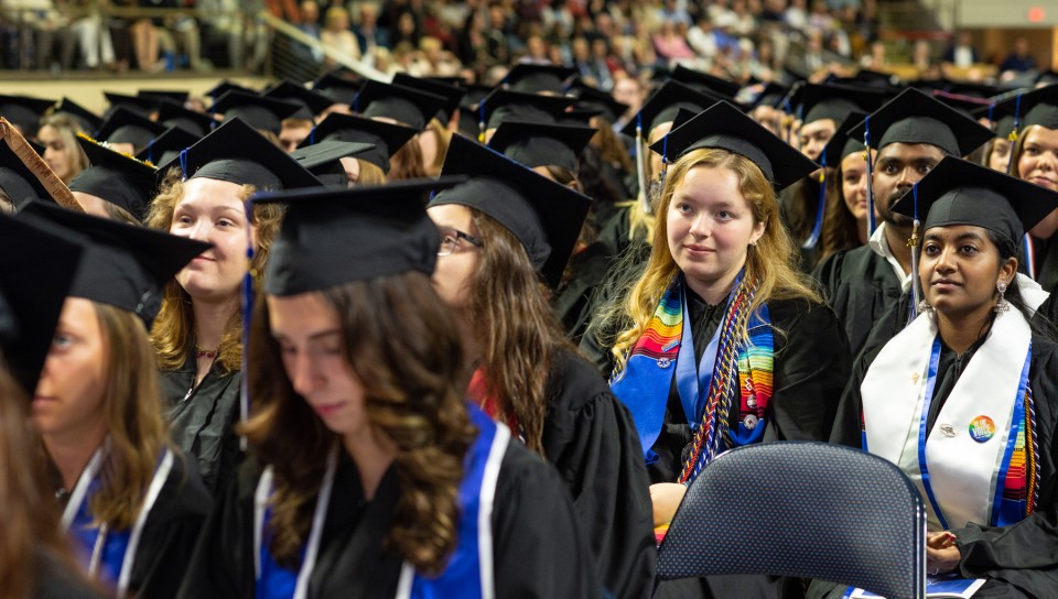 UNE graduates watch the ceremony from their seats