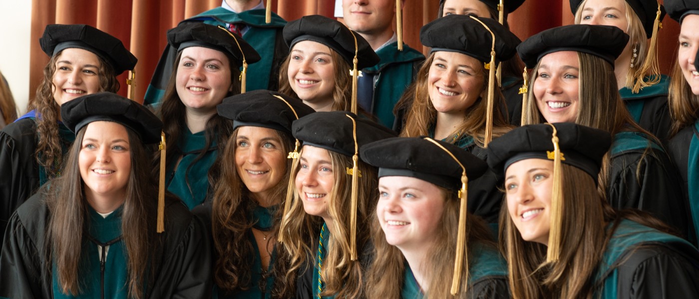 A group of UNE graduates pose for a photo