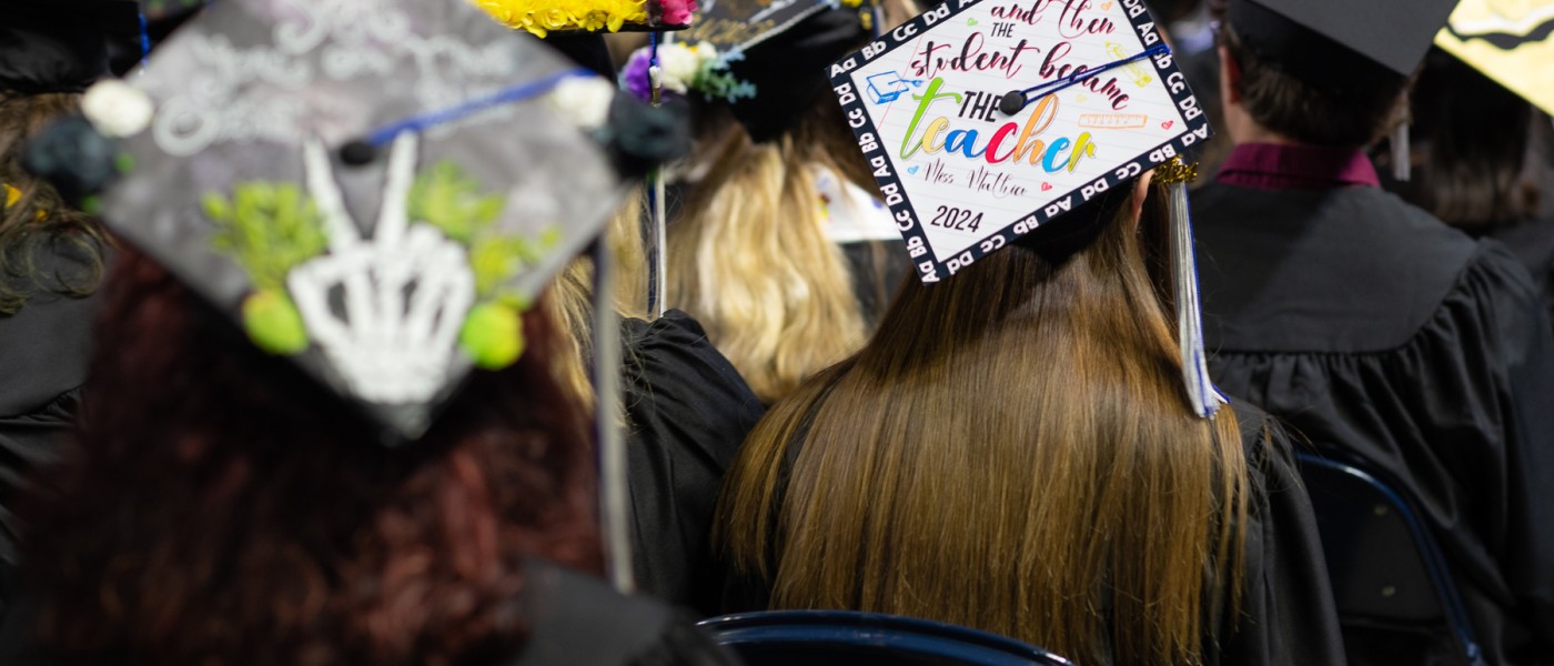 A photo of graduates' caps from behind 