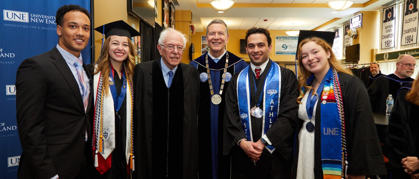 UNE President James Herbert poses with Bernie Sanders and students