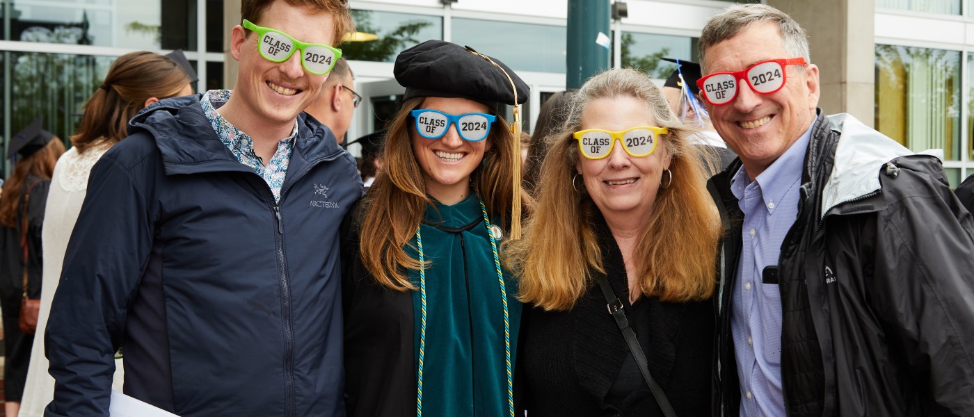 A family poses with "Class of 2024" sunglasses