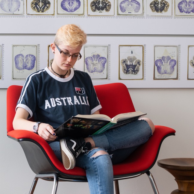 a student studies in an arm chair 