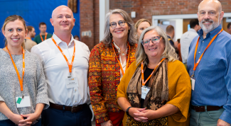 A group of UNE researchers and administrators pose for a photo